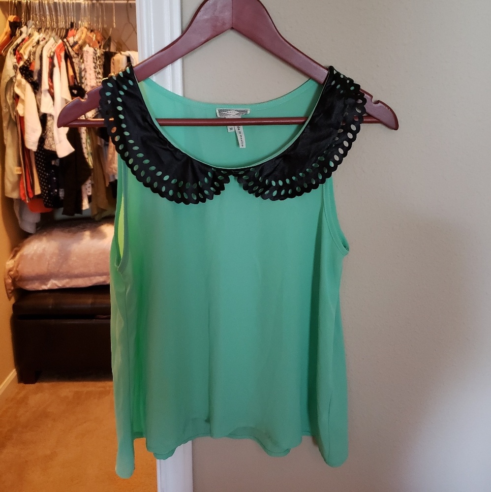 Sleeveless top with faux leather collar